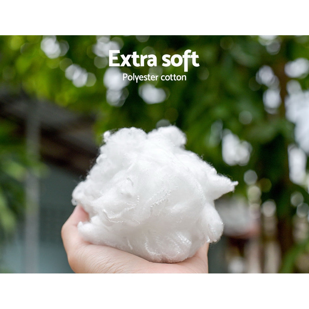 Hand holding the soft polyester filling used in the Plush Calming Dog Bed