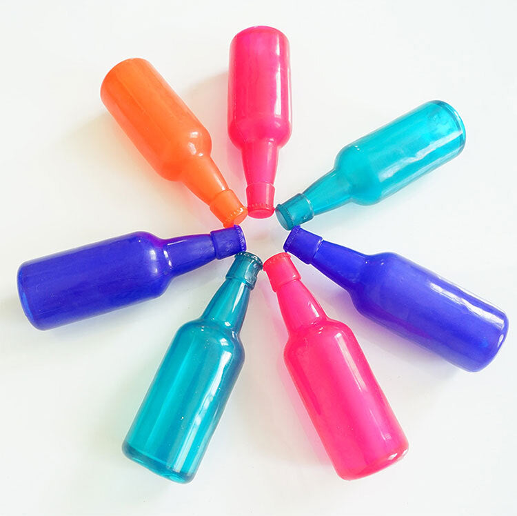 Colourful bottle-shaped Puppy Treat Toys arranged in a circle