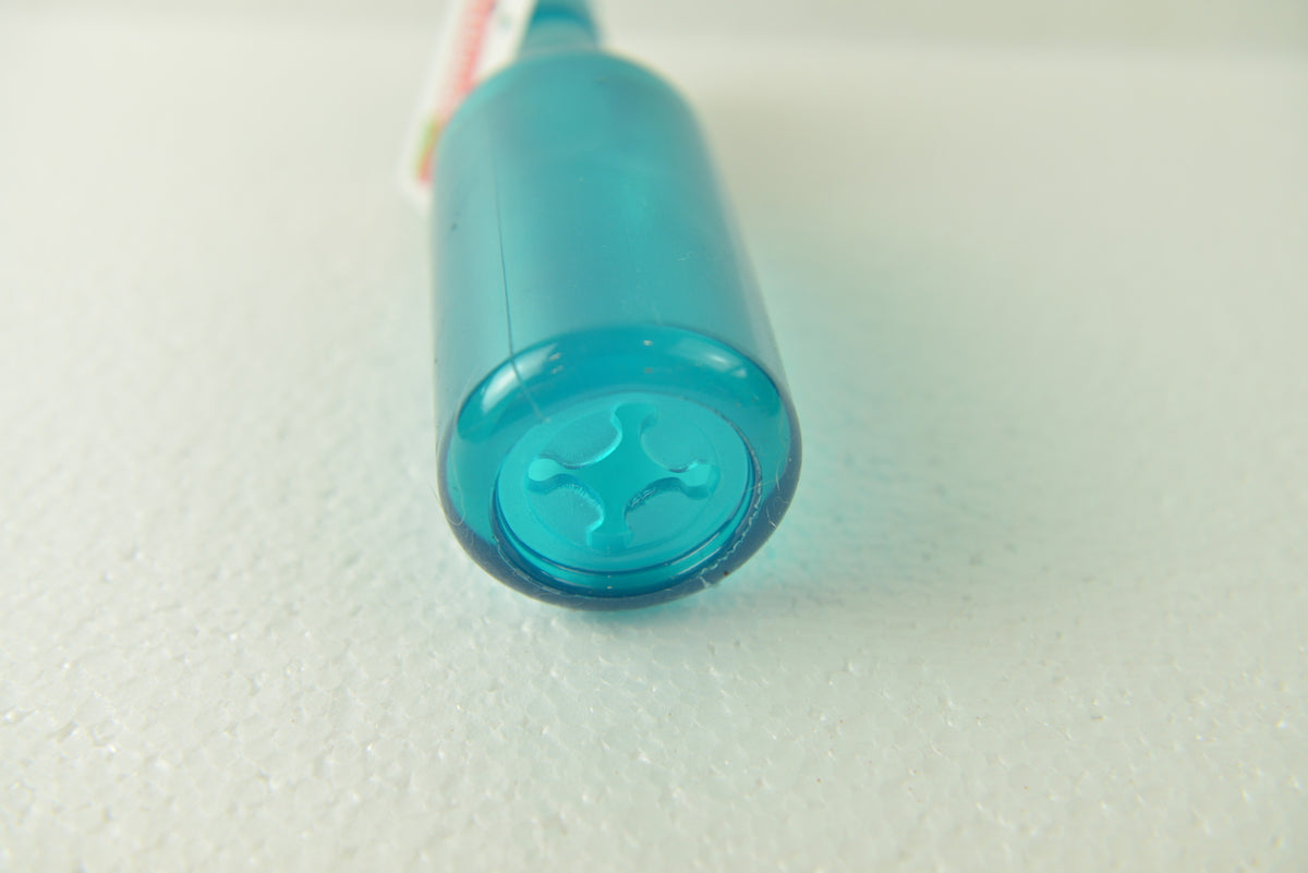 Close up of the cross-shaped treat opening on a teal Puppy Treat Toy