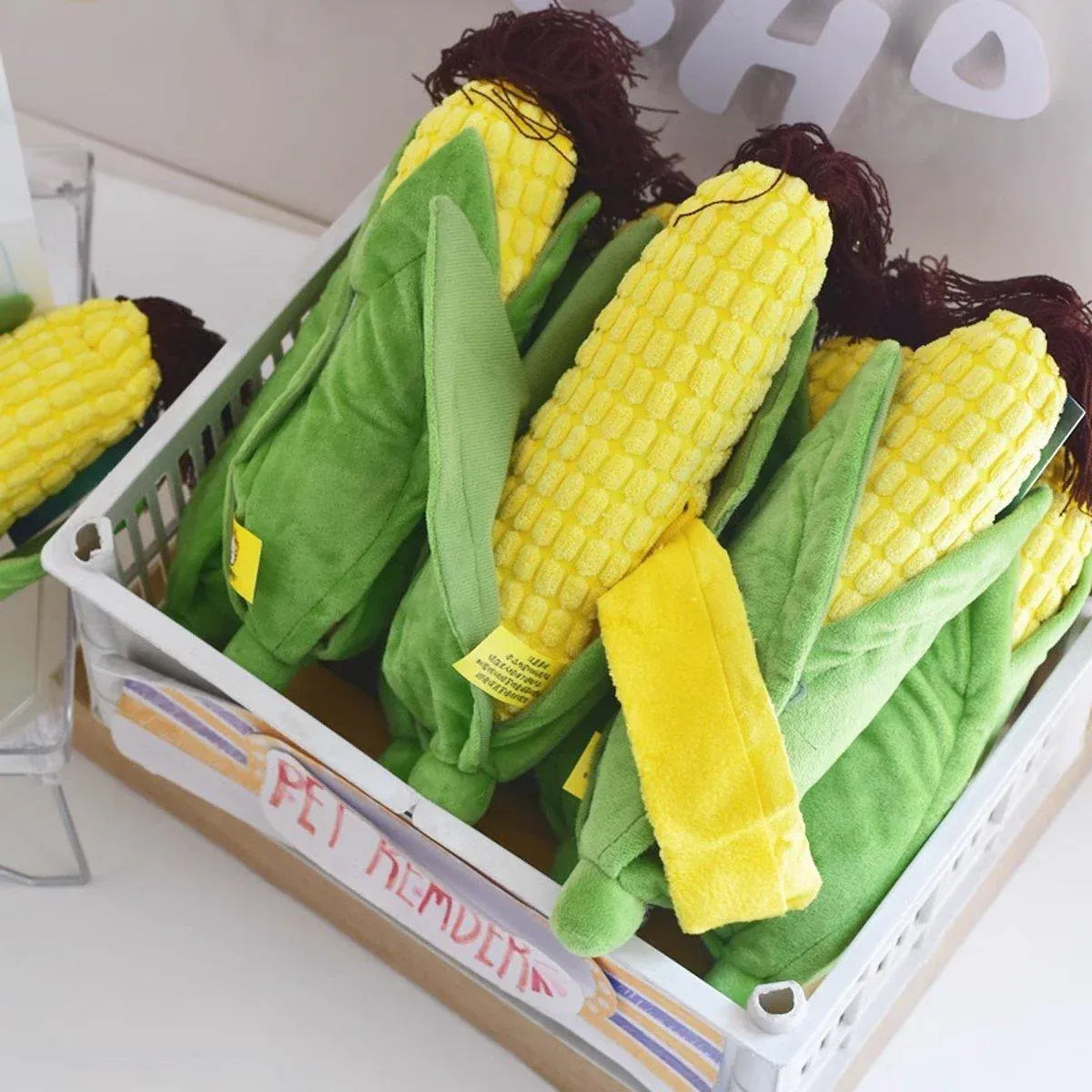 Basket filled with plush Corn Chew Toys for dogs