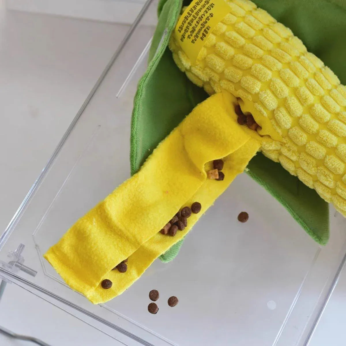 Close up of kibble tucked into the fabric strip of the Corn Chew Toy