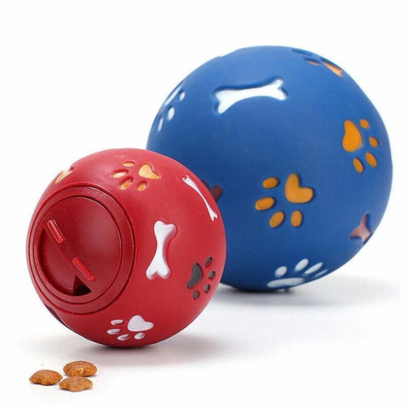 Red and blue Treat Tumbler Balls with a few pieces of kibble