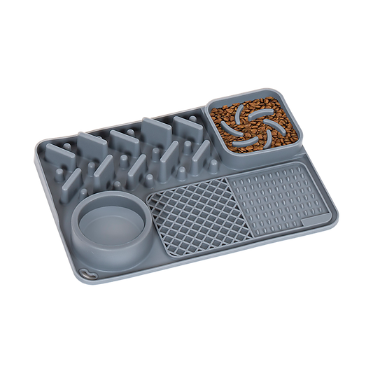 Grey Tough Lick Mat with a built-in bowl, ridges and textured zones, with food in one corner