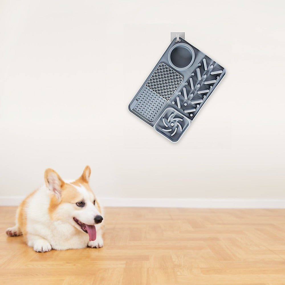 Corgi waiting beside the grey Tough Lick Mat on a timber floor